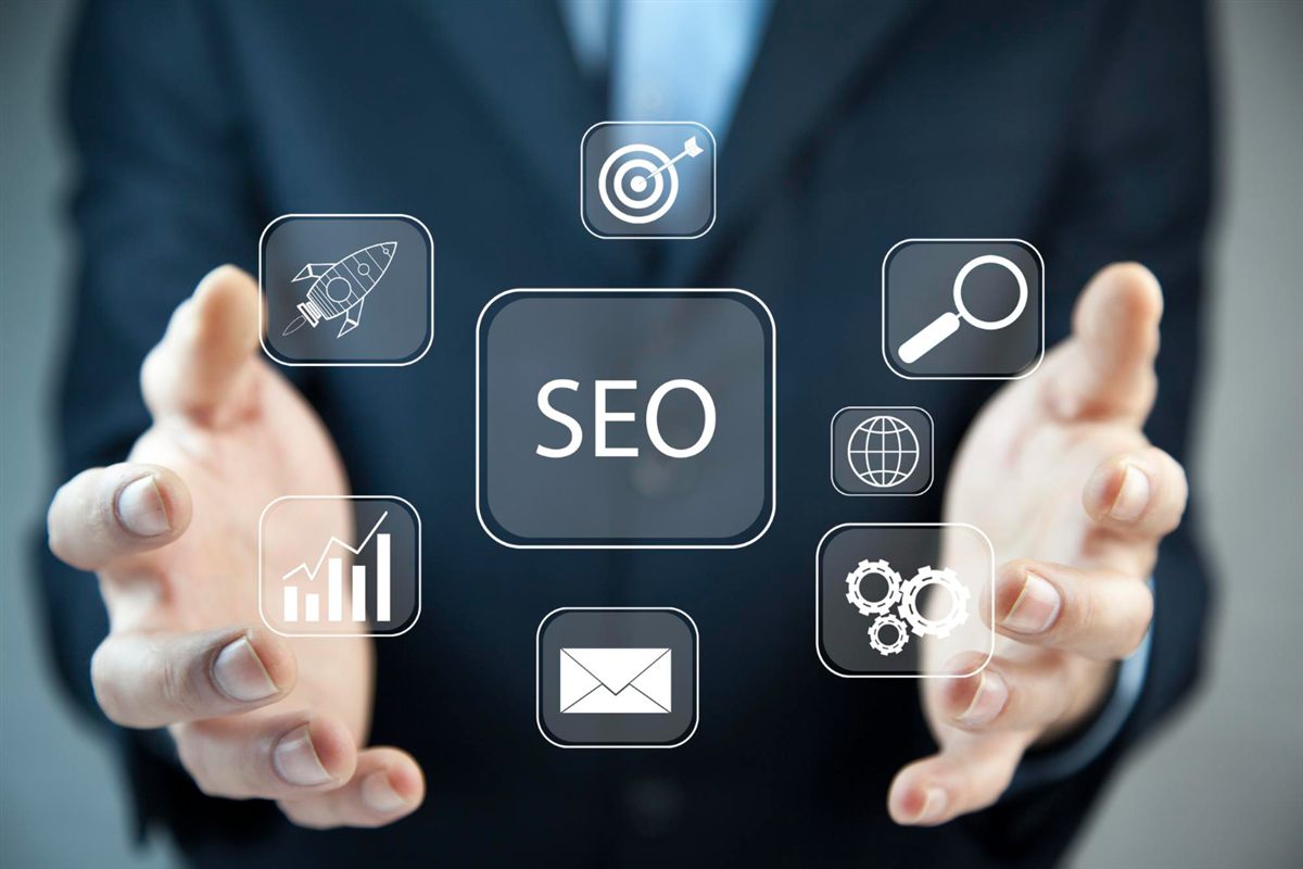 Hands surrounding an SEO graphic and digital marketing icons