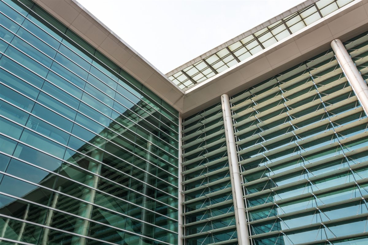 Glass building facade alongside external horizontal louvres