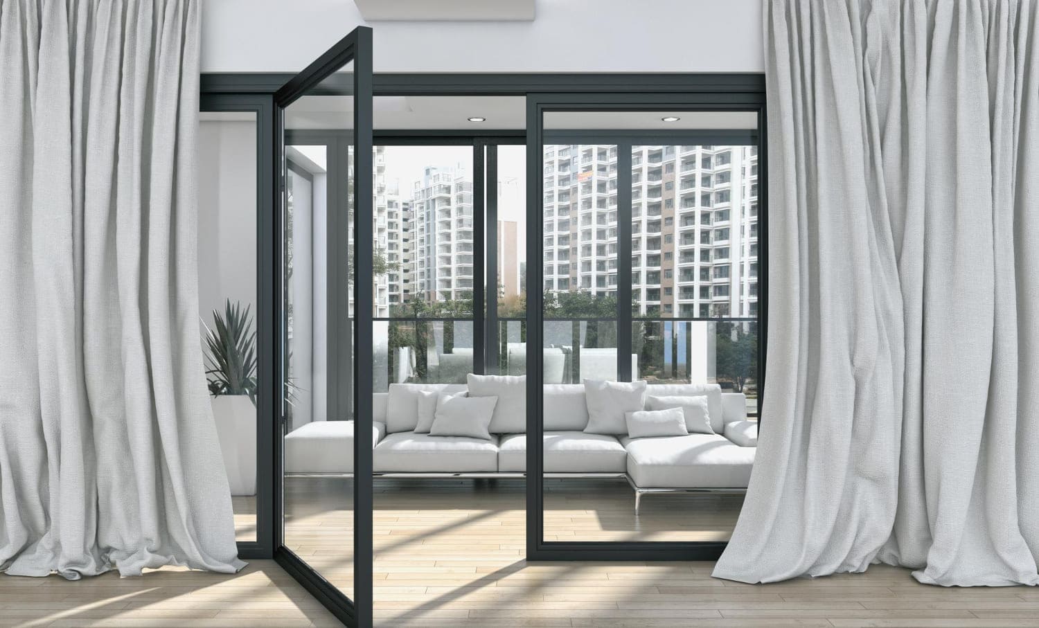 Dark-framed glass doors connecting a living room to a balcony